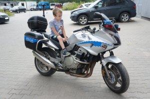 10 letni Kuba siedzacy na motocyklu policyjnym