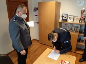 Komendant Powiatowy Policji w Będzinie i policjant podpisujący akt ślubowania