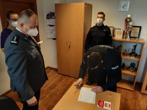 Komendant Powiatowy Policji w Będzinie i policjant podpisujący akt ślubowania