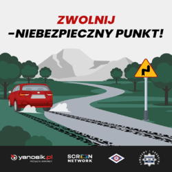 Plakat z napisem zwolnij-niebezpieczny punkt