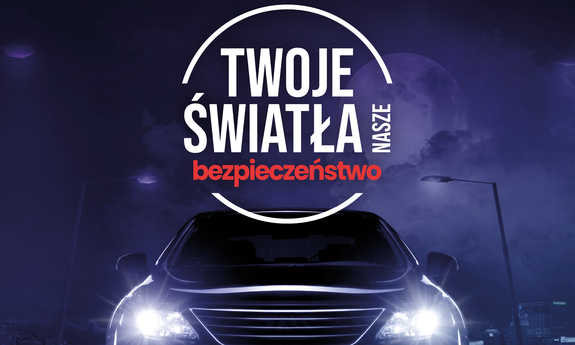 Grafika przedstawiająca samochód z włączonymi światłami oraz napis: Twoje Światła nasze bezpieczeństwo