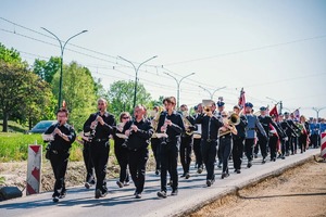 Przemarsz grupy ludzi ulicami miasta.