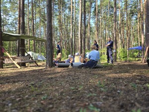 Na zdjęciu widzimy policjantkę i policjanta, którzy rozmawiają z uczestniczkami obozu.