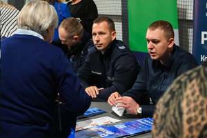 Na zdjęciu policjanci rozmawiają z kobietą.