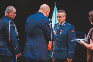 Na zdjęciu Zastępca Komendanta Wojewódzkiego Policji w Katowicach oraz Komendant Powiatowy Policji w Będzinie składają gratulację odznaczonemu policjantowi.